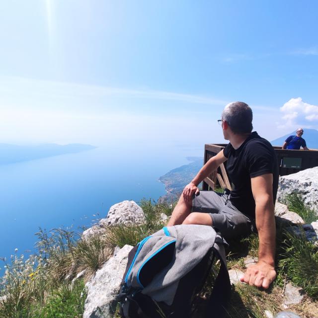 Tamas Molnar sitting on a mountain viewpoint